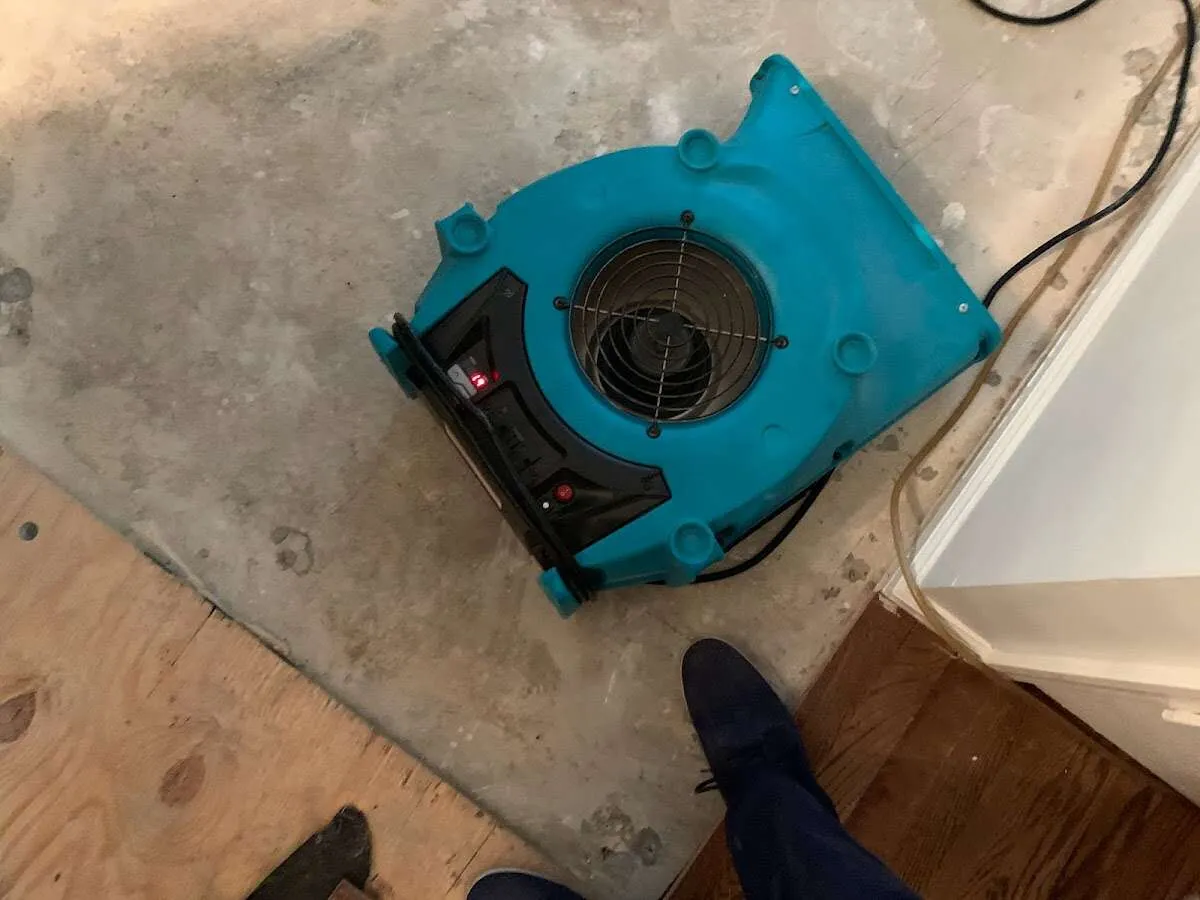 Air mover drying subfloor during Leak Detection & Repair in Little Chute